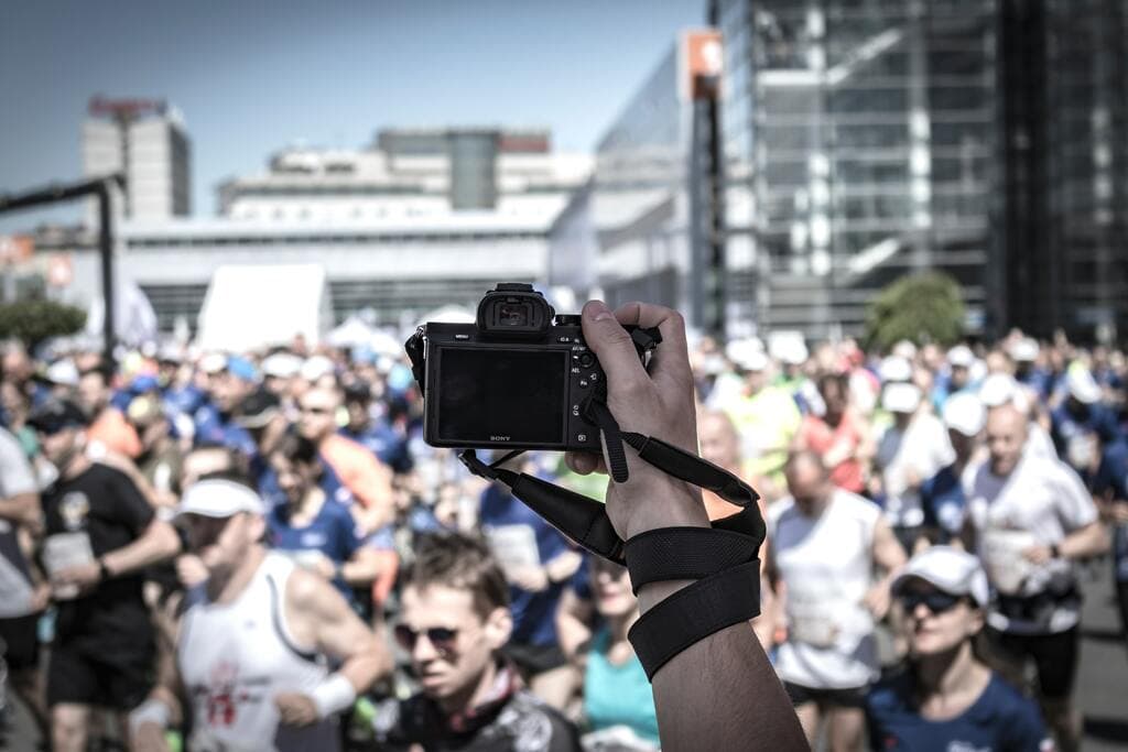 A photographer capturing a shot of a crowd at an event.